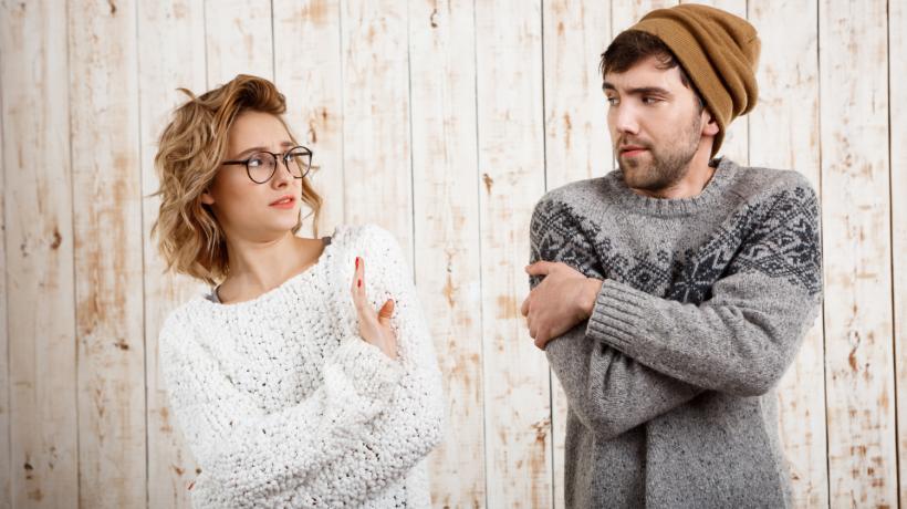 Ein Mann und eine Frau, die sich angucken und die Hände vor der Brust verschränkt haben
