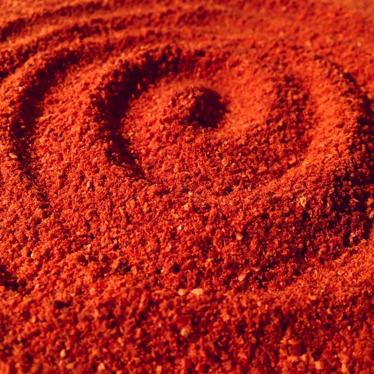 Roter Sand in den ein spiralförmiges Muster gezeichnet ist.