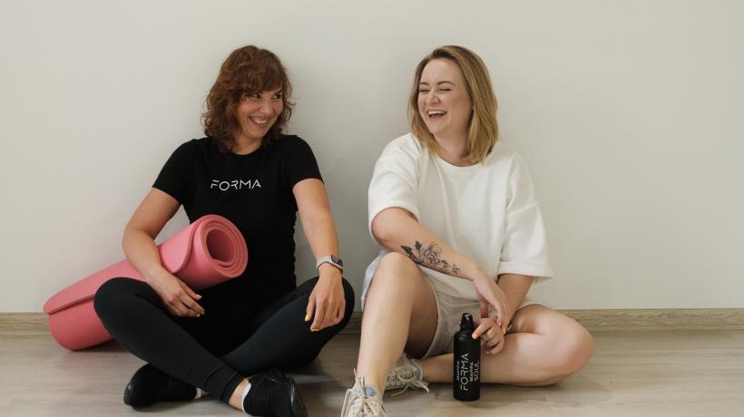 zwei Frauen lachen in Sporthalle