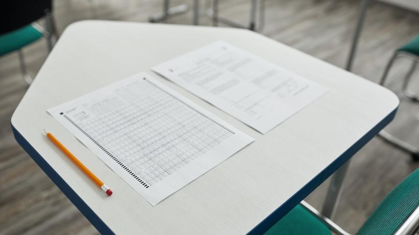 Auf einem Tisch liegen ein Multiple-Choice-Test und ein Stift.