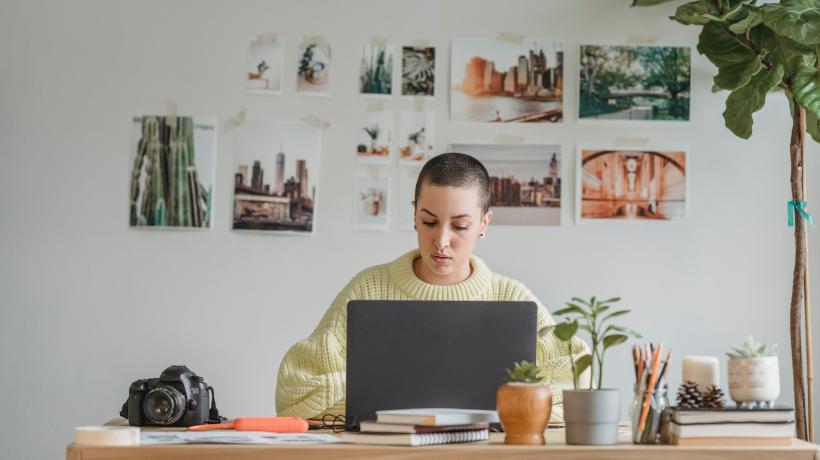 Eine Frau sitzt an einem Laptop am Tisch